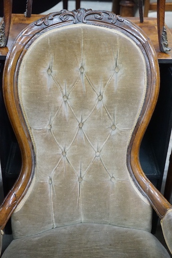 A Victorian carved walnut upholstered spoonback open armchair, width 66cm, depth 72cm, height 98cm